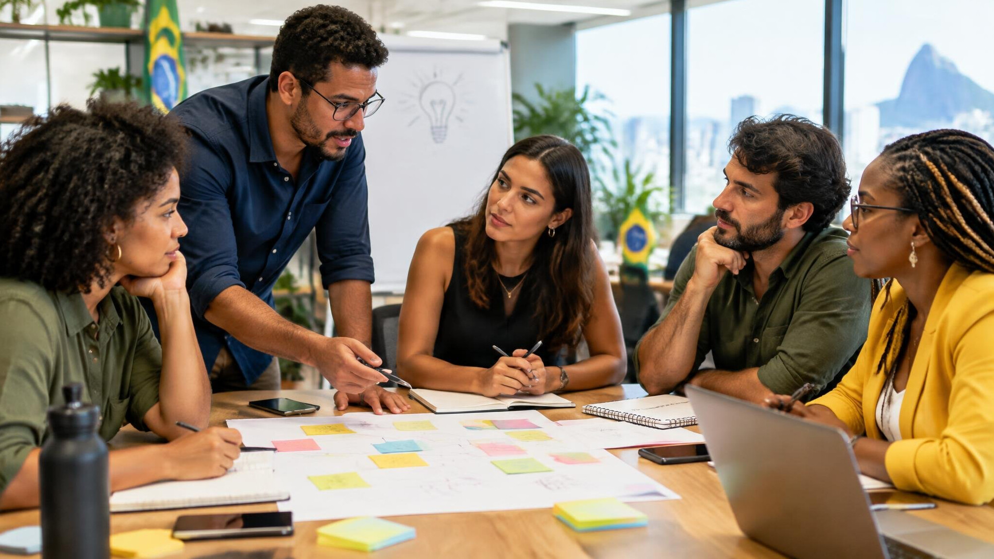 Group of colleagues discussing ideas around a table with notes
